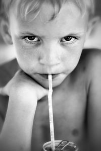 Close-up of cute boy drinking soda