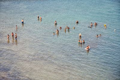 High angle view of people enjoying in sea