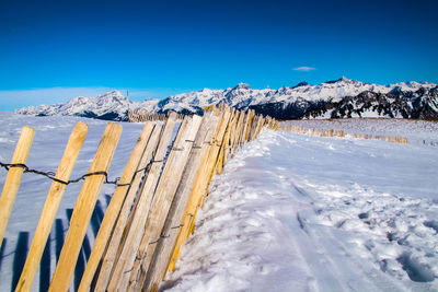 Scenic view of snowcapped mountains against clear blue sky