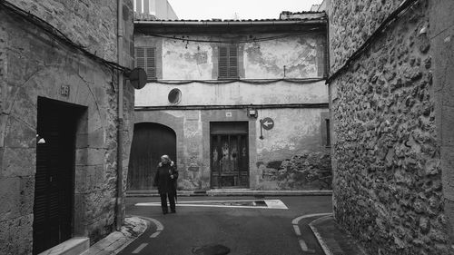 People walking on street amidst buildings