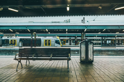 Rear view of man sitting on railing