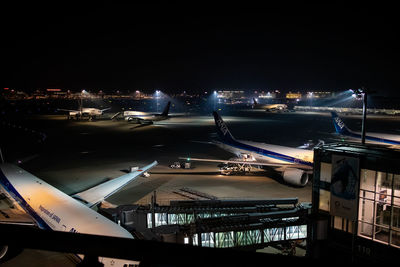 High angle view of illuminated city against sky at night