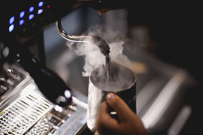 The barista is pouring the coffee mixture.