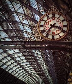 Low angle view of clock against ceiling at railroad station