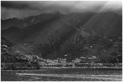 Scenic view of townscape by mountains