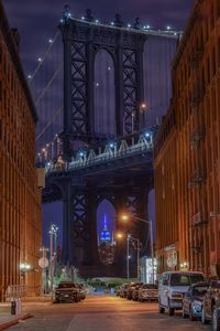 Low angle view of illuminated brooklyn bridge against sky at night