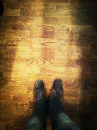 Low section of person standing on tiled floor