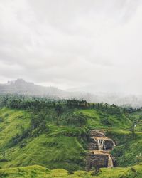 Scenic view of landscape against cloudy sky