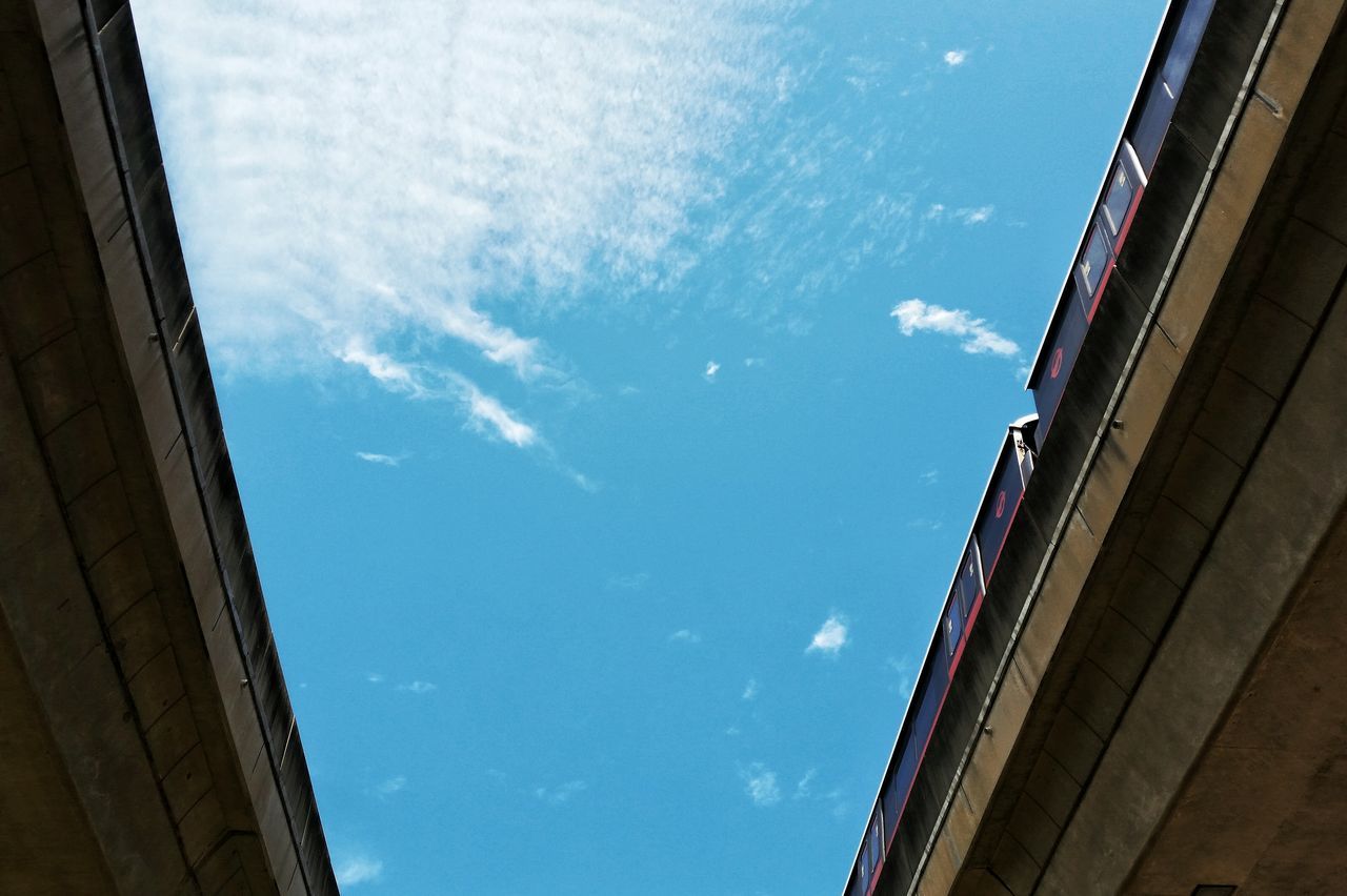 architecture, building exterior, built structure, low angle view, sky, building, blue, window, city, cloud - sky, cloud, residential structure, residential building, day, outdoors, sunlight, glass - material, no people, house, office building