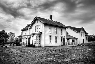 Abandoned building against cloudy sky