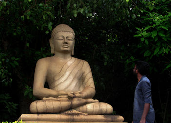 Statue against trees