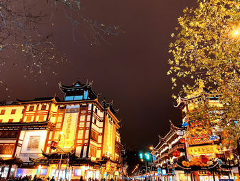 Low angle view of illuminated buildings at night