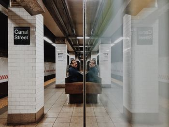 Woman standing at railroad station