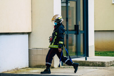 Full length of man on wall against building