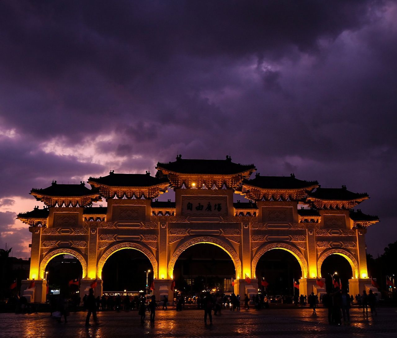 LOW ANGLE VIEW OF ILLUMINATED BUILDING AGAINST SKY