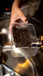 Cropped hand of man preparing coffee