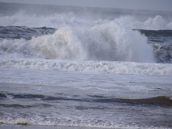 Waves breaking against sea