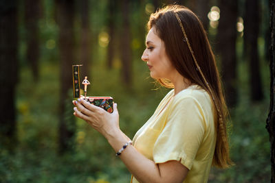 Childhood trauma in adults. outdoor portrait of woman holding a music box in her hands