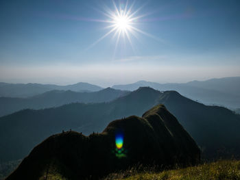 Scenic view of mountains against bright sun