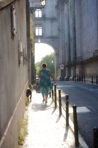 Rear view of people walking on street