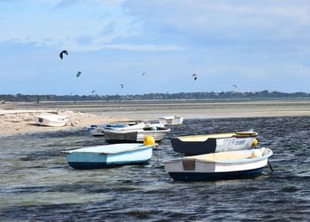 Boats in sea against sky