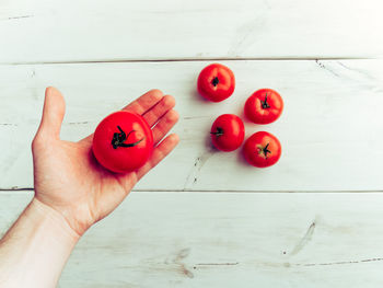 Close-up of hand holding red cherries