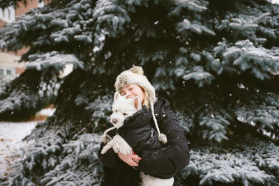 Full length of woman standing in snow