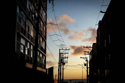 Silhouette of residential buildings and electricity transmission wires 