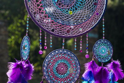 Close-up of multi colored decorations hanging on metal