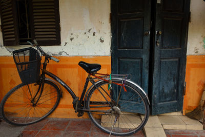 Bicycle parked against building