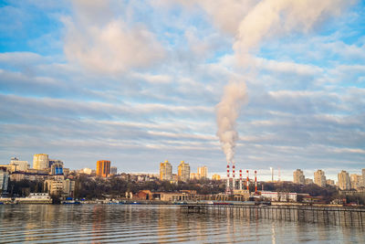 Smoke emitting from chimney against sky