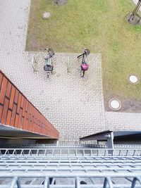 High angle view of parked bicycles on footpath in city