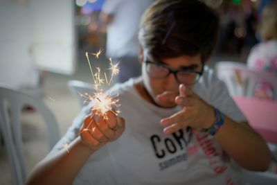 Close-up of woman holding sparkler