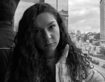 Close-up portrait of young woman in city