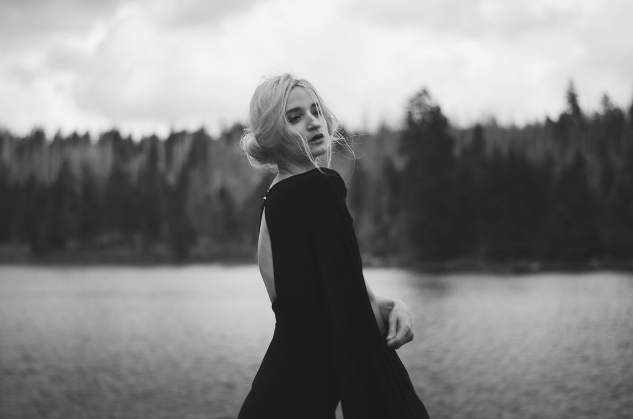 WOMAN STANDING IN LAKE