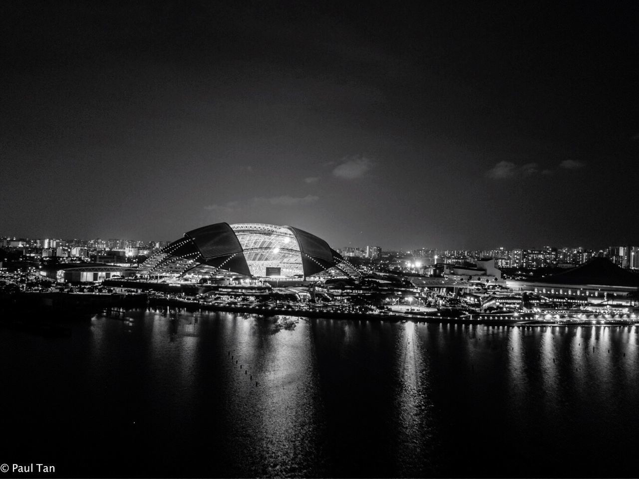 VIEW OF ILLUMINATED CITYSCAPE AT NIGHT