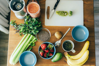 Ingredients for smoothie bowl. chia seed pudding, fruit on wooden table. flat lay, vegan healthy. 