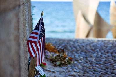 American flag by graveyard against sea