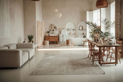 Luxury interior of big bathroom at modern african style with oval bathtub in natural lighting