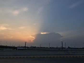 Factory against sky at sunset