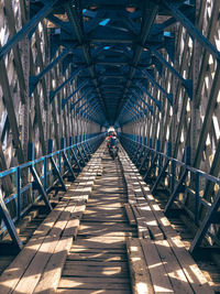 Man walking on footbridge