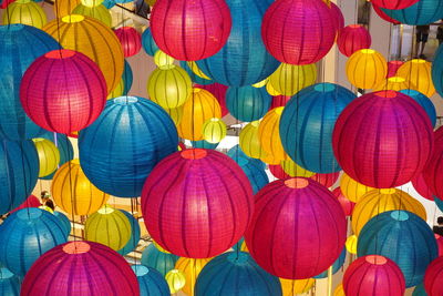 Low angle view of multi colored lanterns hanging in row