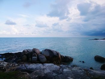 Rocks in sea against sky