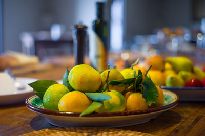 Close-up of lemons in plate on table