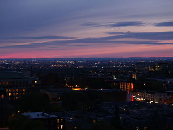 High angle view of illuminated buildings against sky at sunset