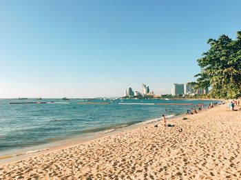 Scenic view of beach against clear sky on sunny day