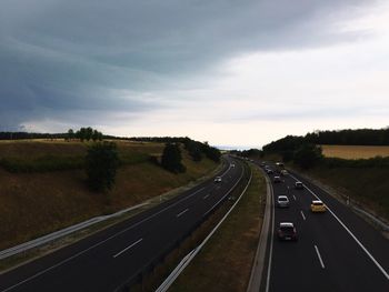 Road passing through landscape against sky