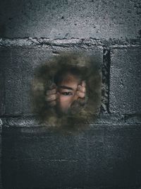 Portrait of young man against wall