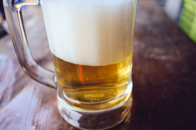 Close-up of beer glass on table