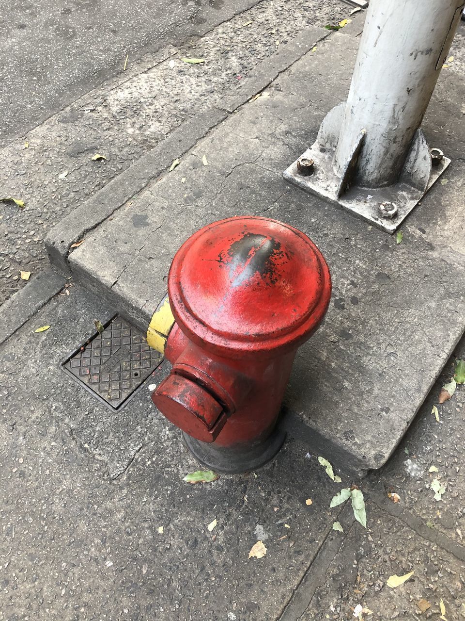 HIGH ANGLE VIEW OF FIRE HYDRANT ON SIDEWALK